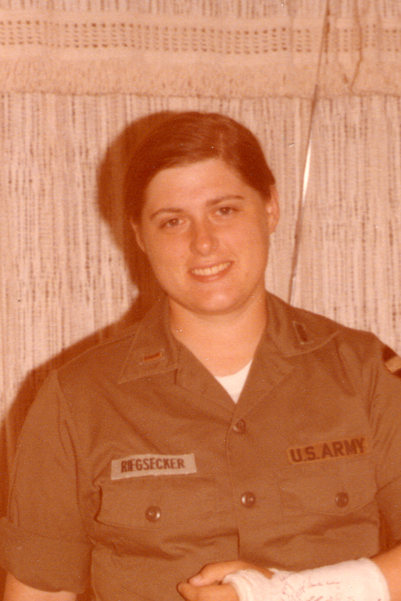 A smiling woman in a US Army uniform.