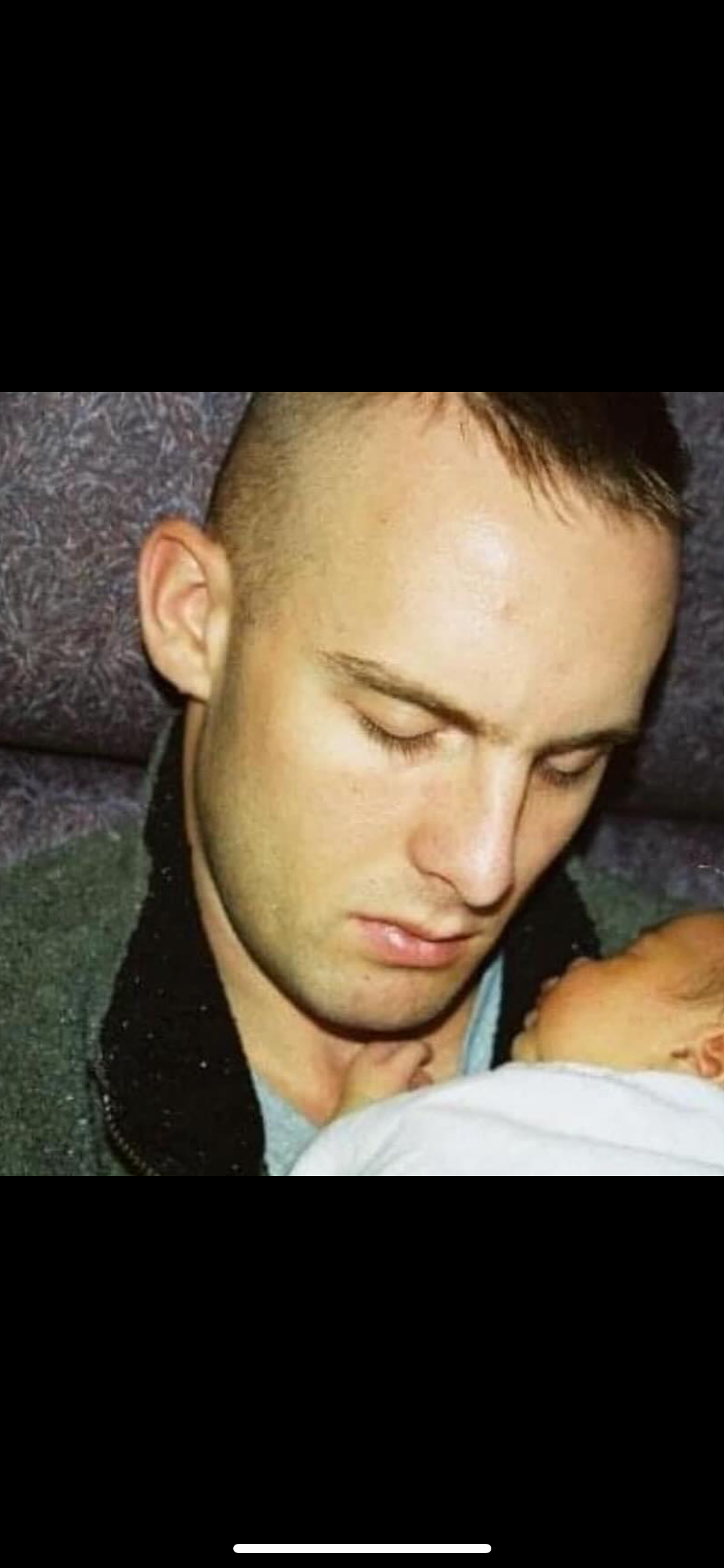 My dad, holding me as a newborn.